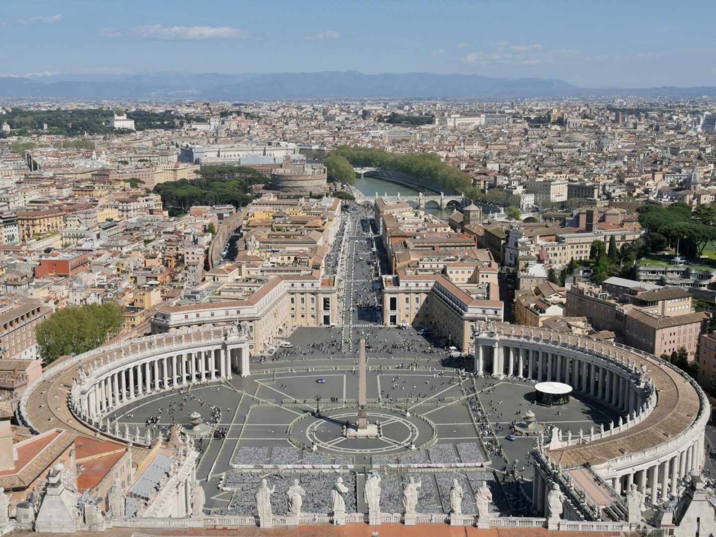 Panoramic aerial shot of St. Peter's Square in Vatican City, capturing the iconic elliptical colonnade.