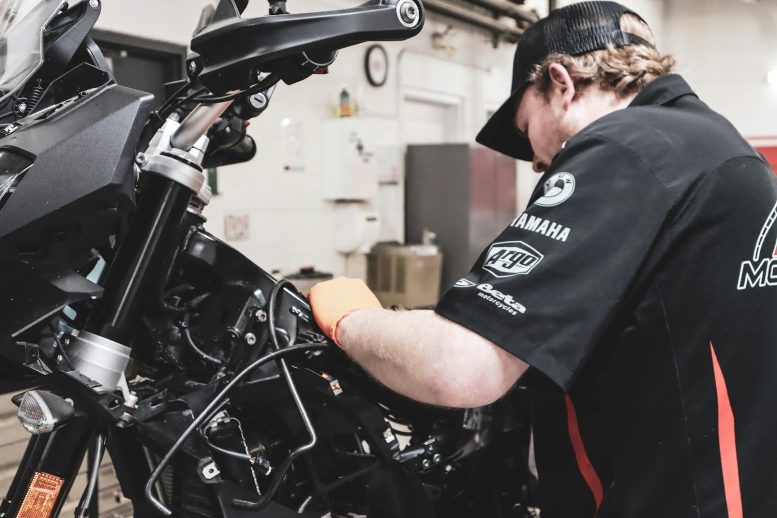 a man working on a motorcycle in a garage